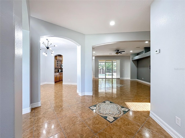 229 Largovista Dr, Oakland, FL 34787 - empty room with tile patterned flooring, ceiling fan, arched walkways, and recessed lighting