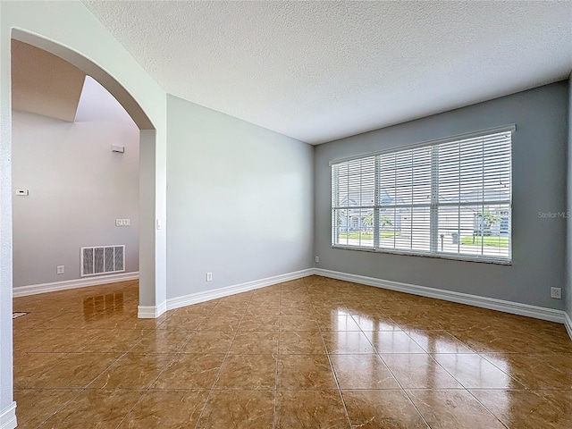 229 Largovista Dr, Oakland, FL 34787 - tiled spare room with a textured ceiling and arched walkways