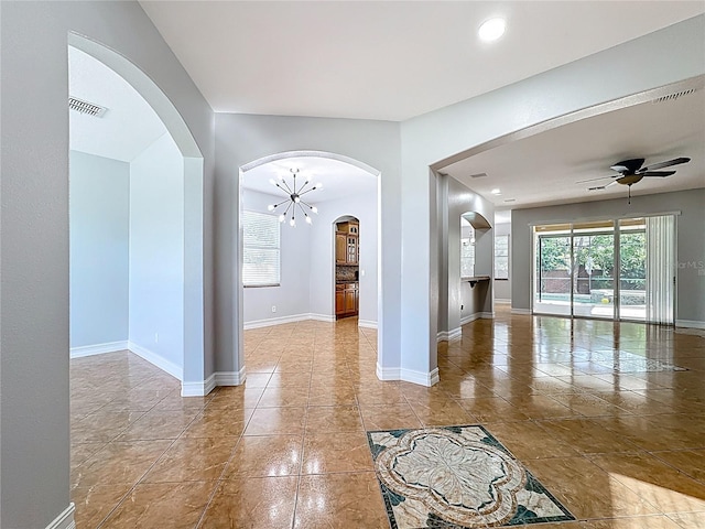 229 Largovista Dr, Oakland, FL 34787 - empty room featuring ceiling fan, tile patterned floors, arched walkways, and recessed lighting
