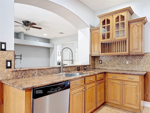 229 Largovista Dr, Oakland, FL 34787 - kitchen with dishwasher, light stone counters, a ceiling fan, and arched walkways