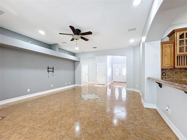 229 Largovista Dr, Oakland, FL 34787 - unfurnished living room featuring ceiling fan, arched walkways, light tile patterned flooring, a textured ceiling, and recessed lighting