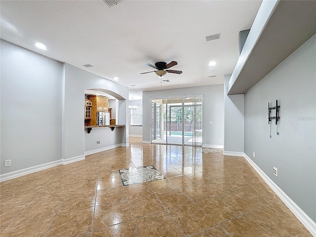 229 Largovista Dr, Oakland, FL 34787 - unfurnished living room featuring a ceiling fan, recessed lighting, arched walkways, and tile patterned floors