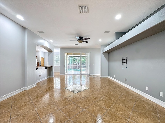 229 Largovista Dr, Oakland, FL 34787 - unfurnished living room featuring a ceiling fan, arched walkways, tile patterned flooring, and recessed lighting
