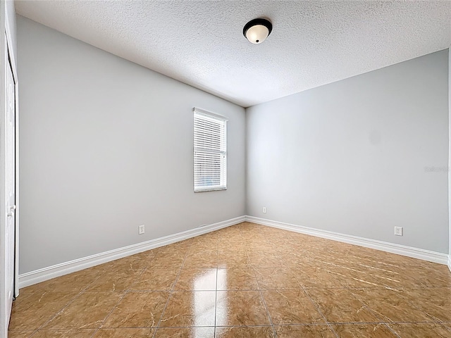 229 Largovista Dr, Oakland, FL 34787 - tiled spare room with a textured ceiling and baseboards