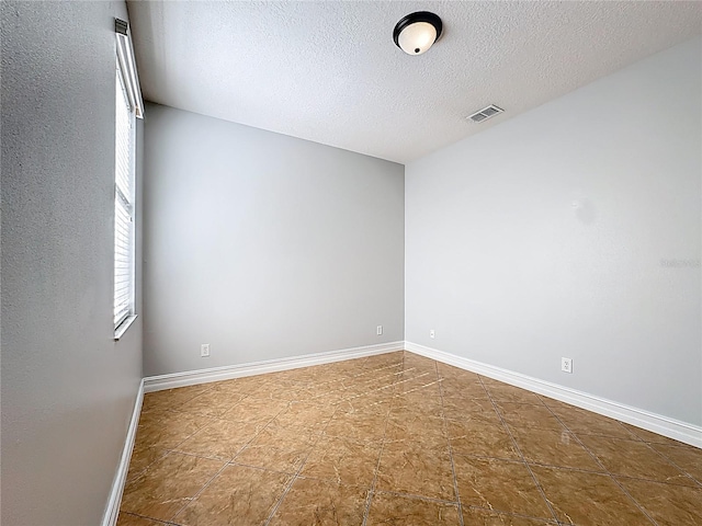 229 Largovista Dr, Oakland, FL 34787 - spare room featuring a textured ceiling and baseboards