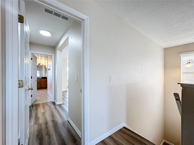 229 Largovista Dr, Oakland, FL 34787 - corridor featuring wood finished floors and a textured ceiling