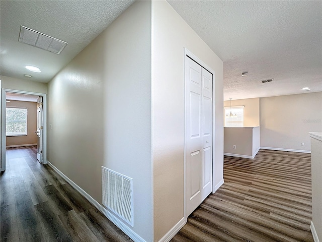 229 Largovista Dr, Oakland, FL 34787 - hallway featuring dark wood-style flooring and a textured ceiling