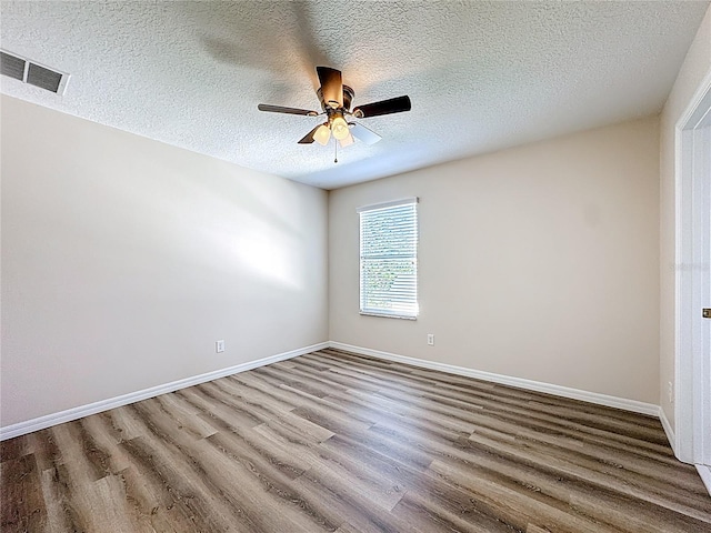 229 Largovista Dr, Oakland, FL 34787 - empty room with wood finished floors, ceiling fan, and a textured ceiling