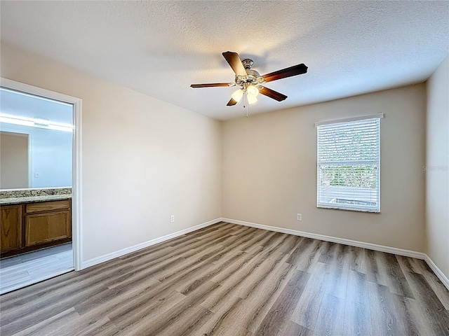229 Largovista Dr, Oakland, FL 34787 - unfurnished bedroom with light wood-style floors, ensuite bath, a textured ceiling, and ceiling fan