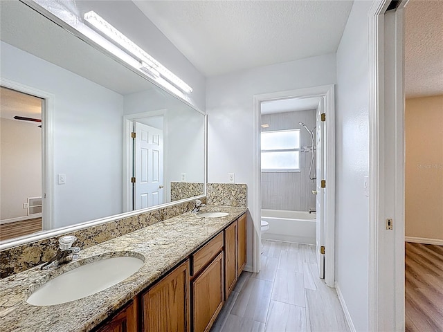 229 Largovista Dr, Oakland, FL 34787 - full bath with double vanity, shower / bathtub combination, and a textured ceiling