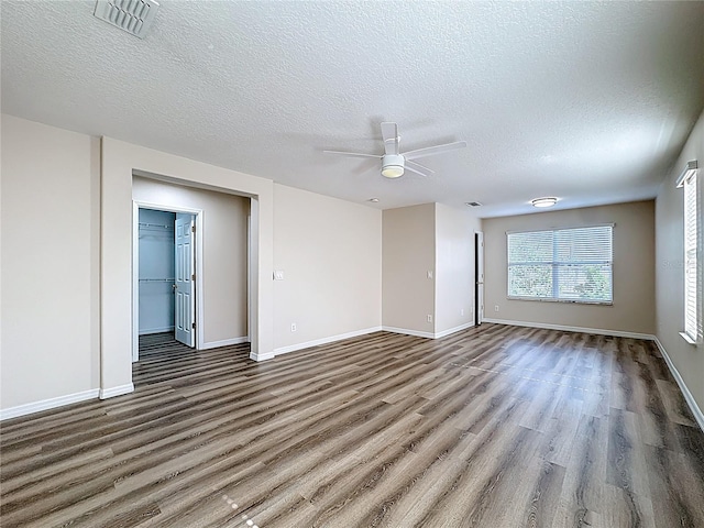 229 Largovista Dr, Oakland, FL 34787 - unfurnished room featuring wood finished floors, ceiling fan, and a textured ceiling