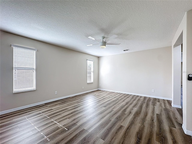 229 Largovista Dr, Oakland, FL 34787 - unfurnished room with wood finished floors, ceiling fan, and a textured ceiling