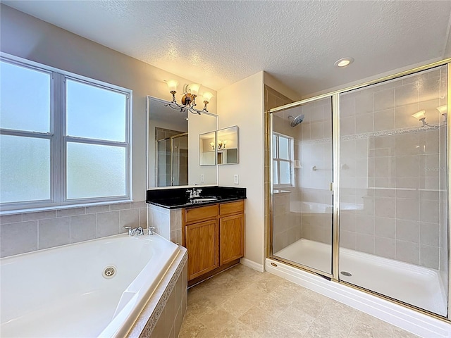 229 Largovista Dr, Oakland, FL 34787 - bathroom with a stall shower, a whirlpool tub, vanity, a chandelier, and a textured ceiling