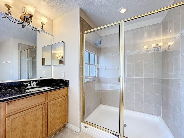 229 Largovista Dr, Oakland, FL 34787 - bathroom featuring a textured ceiling, a shower stall, vanity, tile patterned flooring, and a chandelier