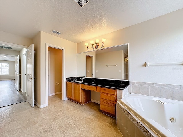 229 Largovista Dr, Oakland, FL 34787 - bathroom with a whirlpool tub, vanity, and a textured ceiling