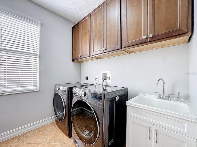 229 Largovista Dr, Oakland, FL 34787 - laundry area featuring separate washer and dryer, cabinet space, light tile patterned floors, a textured ceiling, and plenty of natural light