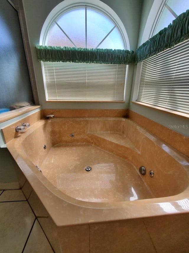 8630 Knottingham Dr, Kissimmee, FL 34747 - full bathroom with a tub with jets and tile patterned floors