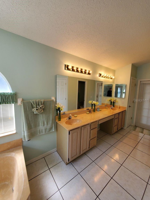 8630 Knottingham Dr, Kissimmee, FL 34747 - full bathroom with double vanity, a textured ceiling, tile patterned floors, and a tub