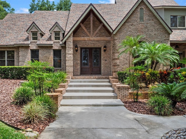 9045 Mossy Oak Ln, Clermont, FL 34711 - view of front of house with french doors and brick siding