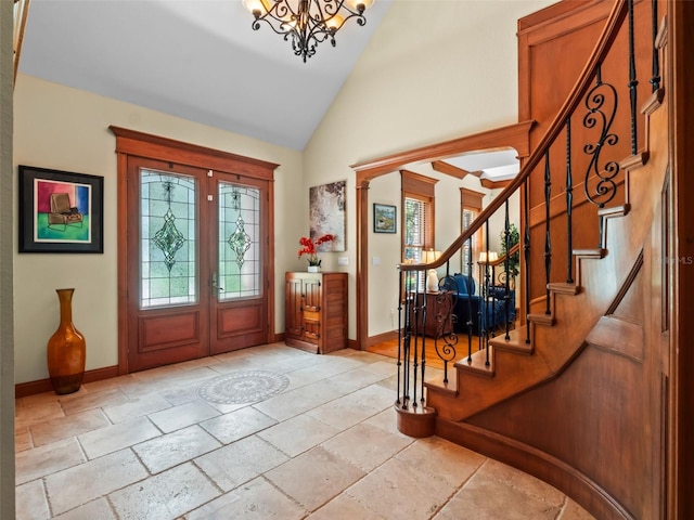 9045 Mossy Oak Ln, Clermont, FL 34711 - foyer featuring plenty of natural light, stone tile floors, stairs, a chandelier, and high vaulted ceiling