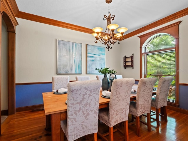 9045 Mossy Oak Ln, Clermont, FL 34711 - dining room with crown molding, a chandelier, and dark wood-style flooring
