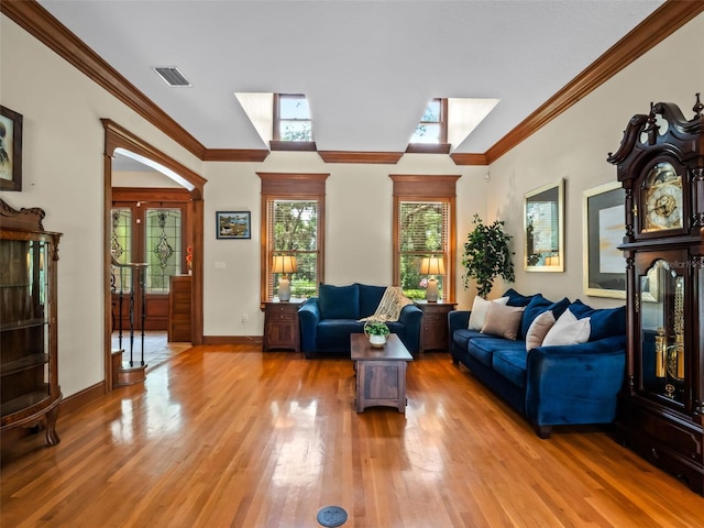 9045 Mossy Oak Ln, Clermont, FL 34711 - living room featuring light wood-style flooring, ornamental molding, and a skylight