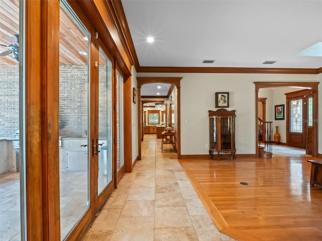 9045 Mossy Oak Ln, Clermont, FL 34711 - hall with french doors, arched walkways, ornamental molding, recessed lighting, and stairs