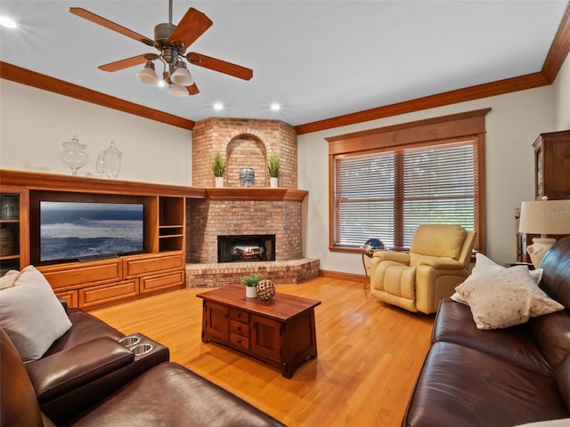 9045 Mossy Oak Ln, Clermont, FL 34711 - living room featuring crown molding, light wood finished floors, ceiling fan, a fireplace, and recessed lighting