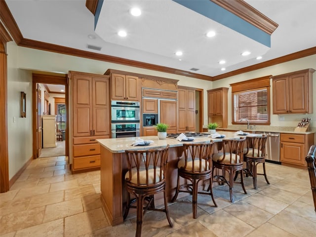 9045 Mossy Oak Ln, Clermont, FL 34711 - kitchen featuring appliances with stainless steel finishes, crown molding, a kitchen island, a breakfast bar, and recessed lighting