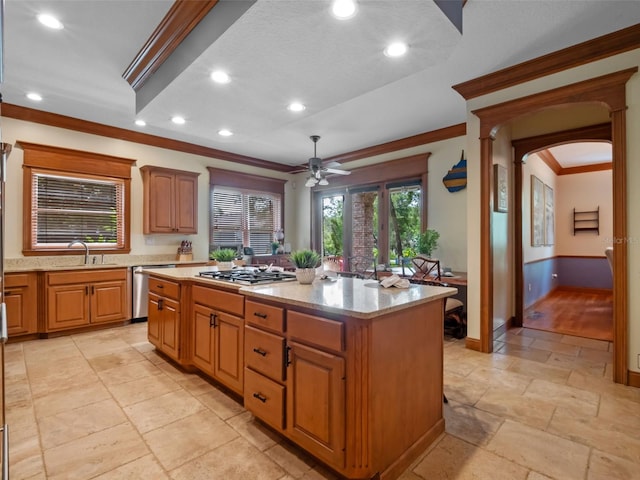 9045 Mossy Oak Ln, Clermont, FL 34711 - kitchen featuring stainless steel appliances, ornamental molding, ceiling fan, arched walkways, and a center island