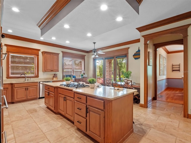 9045 Mossy Oak Ln, Clermont, FL 34711 - kitchen featuring stainless steel appliances, a ceiling fan, crown molding, a center island, and light stone counters