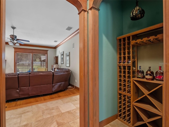9045 Mossy Oak Ln, Clermont, FL 34711 - wine room with crown molding, a ceiling fan, and wood finished floors