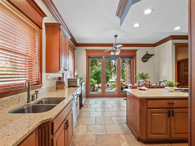 9045 Mossy Oak Ln, Clermont, FL 34711 - kitchen with ornamental molding, light stone counters, recessed lighting, ceiling fan, and brown cabinetry