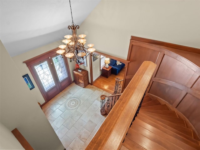 9045 Mossy Oak Ln, Clermont, FL 34711 - foyer featuring a chandelier, vaulted ceiling, stairs, and wood finished floors