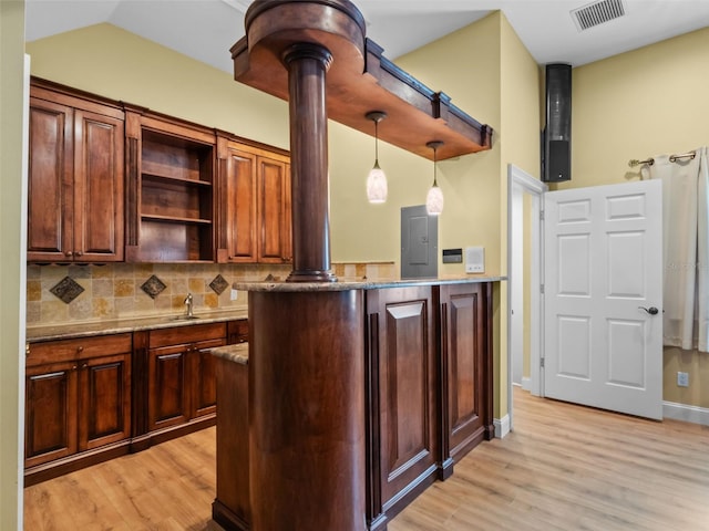 9045 Mossy Oak Ln, Clermont, FL 34711 - kitchen featuring light wood finished floors, ornate columns, tasteful backsplash, open shelves, and stone counters