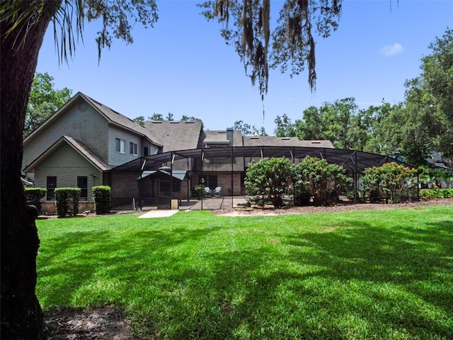 9045 Mossy Oak Ln, Clermont, FL 34711 - back of property with a lawn and glass enclosure