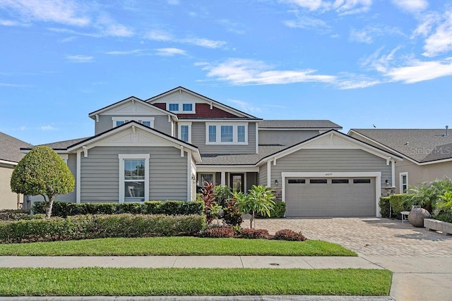 14897 Ellingsworth Ln, Winter Garden, FL 34787 - view of front of house with driveway, a garage, and roof with shingles