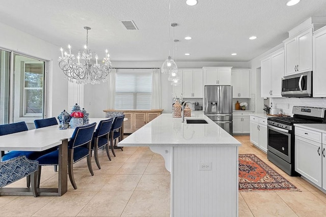 14897 Ellingsworth Ln, Winter Garden, FL 34787 - kitchen featuring appliances with stainless steel finishes, a chandelier, light countertops, light tile patterned floors, and recessed lighting