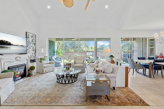 14897 Ellingsworth Ln, Winter Garden, FL 34787 - living area featuring high vaulted ceiling, a glass covered fireplace, a chandelier, tile patterned flooring, and recessed lighting