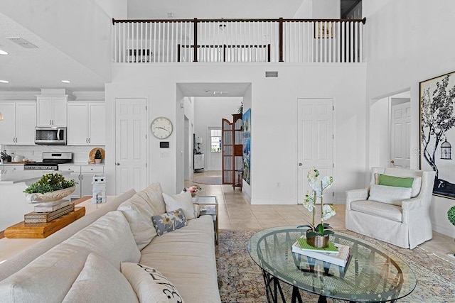 14897 Ellingsworth Ln, Winter Garden, FL 34787 - living room featuring a high ceiling, light tile patterned flooring, and recessed lighting