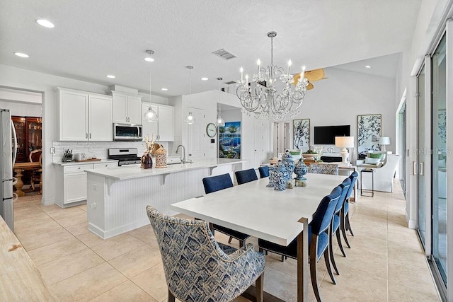 14897 Ellingsworth Ln, Winter Garden, FL 34787 - dining area featuring a chandelier, light tile patterned floors, and recessed lighting