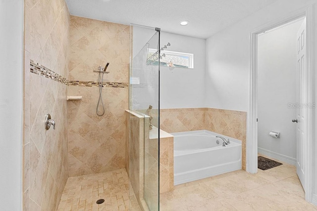 14897 Ellingsworth Ln, Winter Garden, FL 34787 - bathroom with a garden tub, tiled shower, and recessed lighting