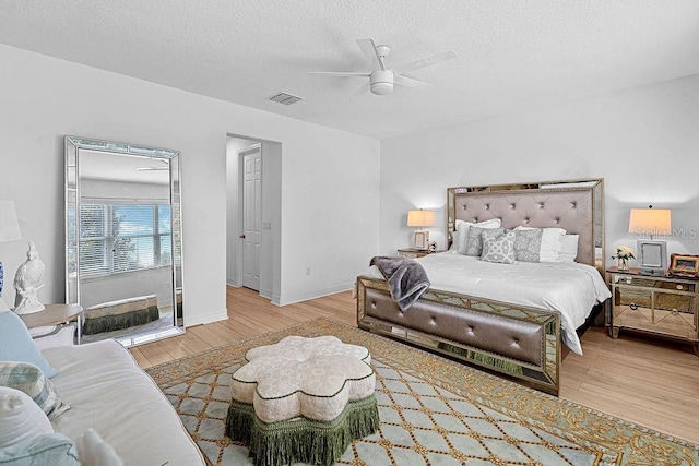 14897 Ellingsworth Ln, Winter Garden, FL 34787 - bedroom with wood finished floors, a textured ceiling, and ceiling fan