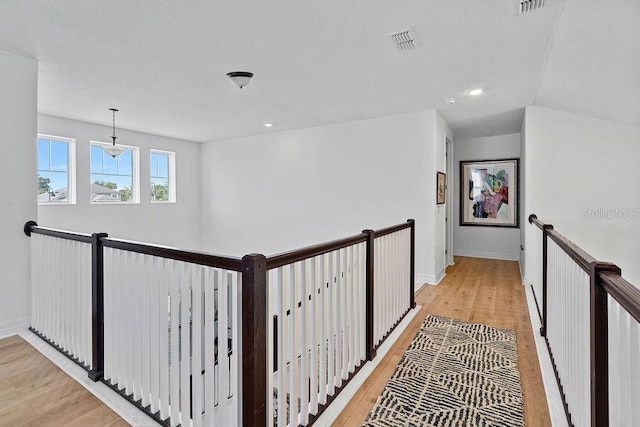14897 Ellingsworth Ln, Winter Garden, FL 34787 - corridor with an upstairs landing, light wood-style flooring, and recessed lighting