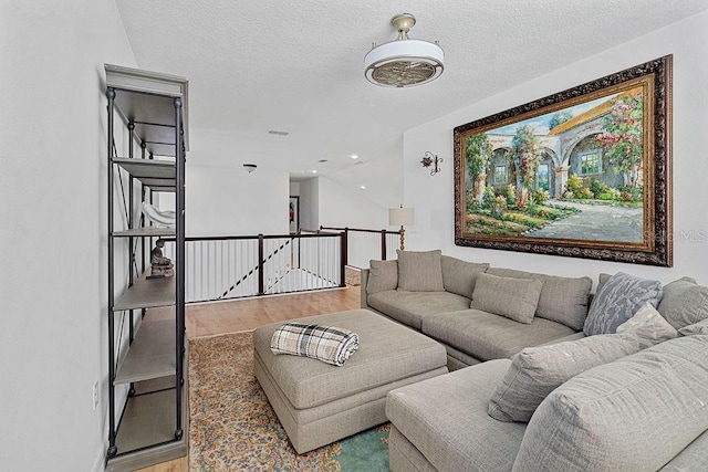 14897 Ellingsworth Ln, Winter Garden, FL 34787 - living area featuring wood finished floors and a textured ceiling