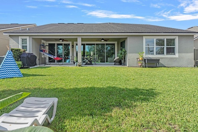 14897 Ellingsworth Ln, Winter Garden, FL 34787 - rear view of property with ceiling fan, stucco siding, a yard, and a patio area
