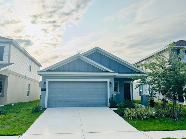 439 Cool Summer Ln, Davenport, FL 33837 - view of front of house with board and batten siding, driveway, an attached garage, and stucco siding