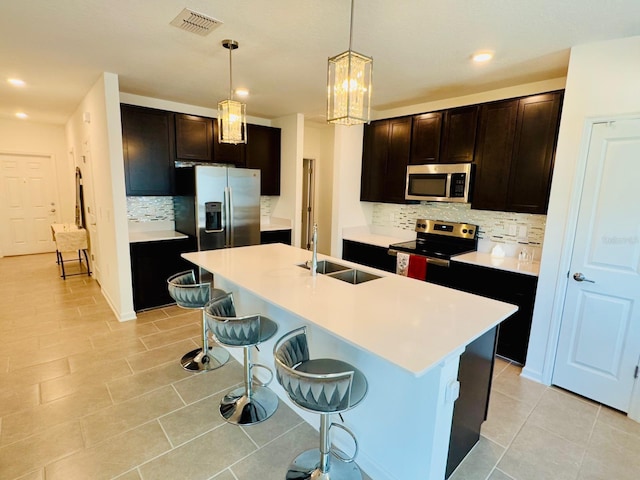 439 Cool Summer Ln, Davenport, FL 33837 - kitchen with stainless steel appliances, decorative backsplash, recessed lighting, a breakfast bar area, and light tile patterned floors