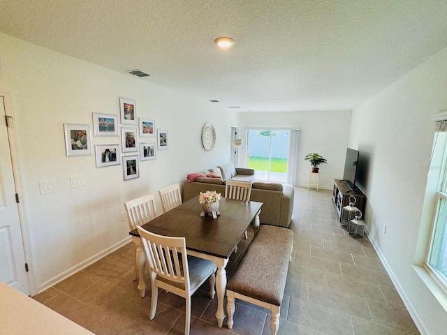 439 Cool Summer Ln, Davenport, FL 33837 - dining area with a textured ceiling and tile patterned floors