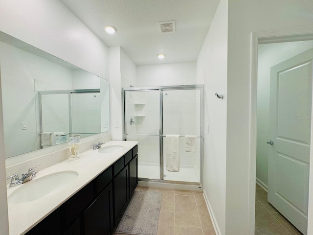 439 Cool Summer Ln, Davenport, FL 33837 - bathroom featuring a stall shower, double vanity, tile patterned flooring, and recessed lighting